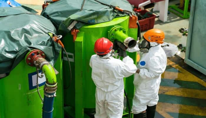 Who Makes the World: What Companies Are In The Basic Industries Field - Finsurancebiz Basic Industries Field: Workers in protective gear conducting operations at an industrial facility.