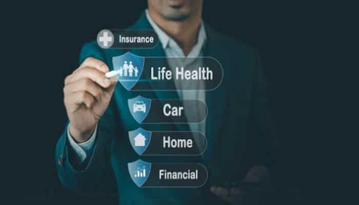 Types of Insurance: What You Need and Why - finsurancebiz - Finsurancebiz Types of Insurance: A person in a suit interacting with a digital interface showing icons for various insurance types such as life, health, car, home, and financial.