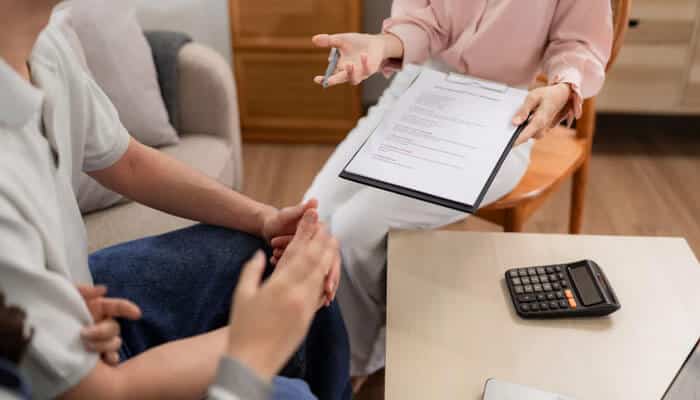 Security Finance Solutions for Smarter Financial Management - finsurancebiz - Finsurancebiz Security finance consultation showing borrower reviewing loan documents with financial advisor for responsible lending and risk control